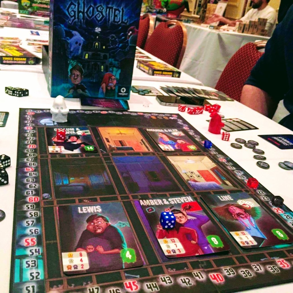 A photo of the board game Ghostel. The board is the main focus of the photo, which looks like a cross section of a hotel with scared guests (cards). 