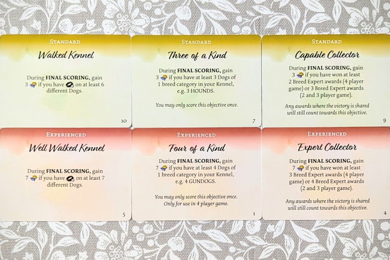 Some standard and experienced objective cards. Standard cards are worth 3 points, and an example is "During final scoring, gain 3 reputation points if you have leads on at least 6 different dogs". All experienced objectives are worth 7 points, and an example is "During final scoring, gain 7 reputation points if you have leads on at least 7 dogs."