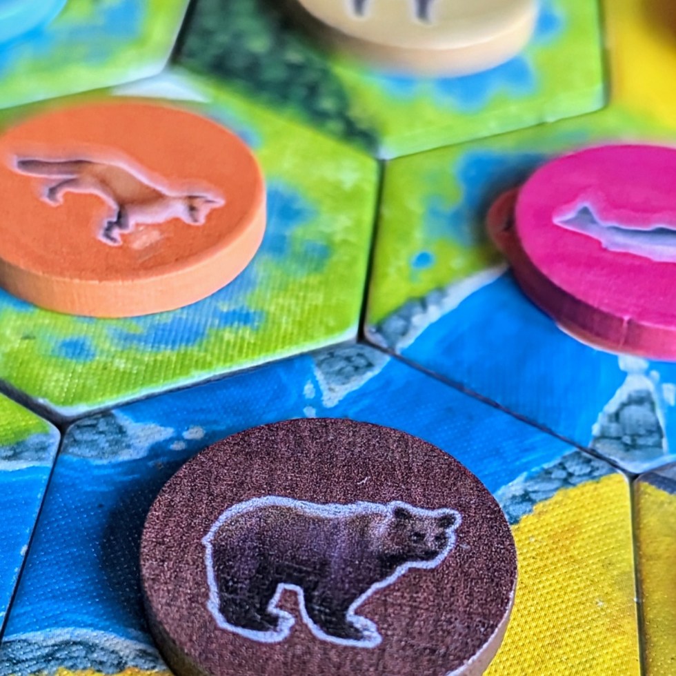 Zoomed in photo showing some Cascadia tiles with Wildlife tokens placed on top