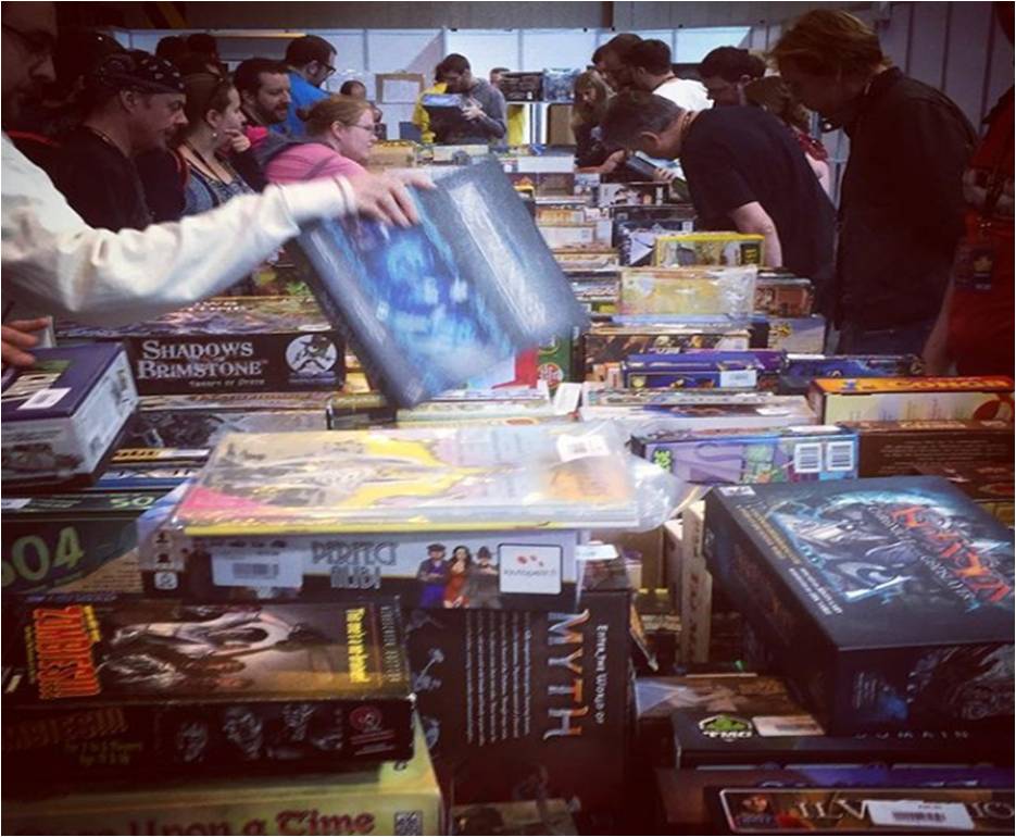 A photo showing the UKGE 2017 Bring and Buy Sale. Photo shows someone picking up Android Netrunner published by Fantasy Flight Games.
