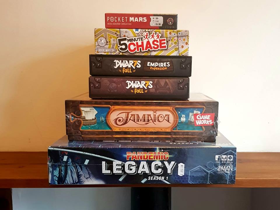 A photo of my new buys! Pocket Mars, 5 Minute Chase, Dwar7s Fall, Jamaica, and Pandemic Legacy Season 1.